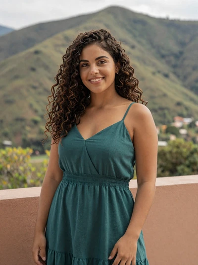 Daniela, 28, Honduran single from Tegucigalpa smiling on a terrace with mountain views